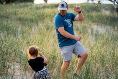 father and daughter playing in a meadow