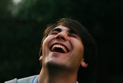 man in gray sweater smiling